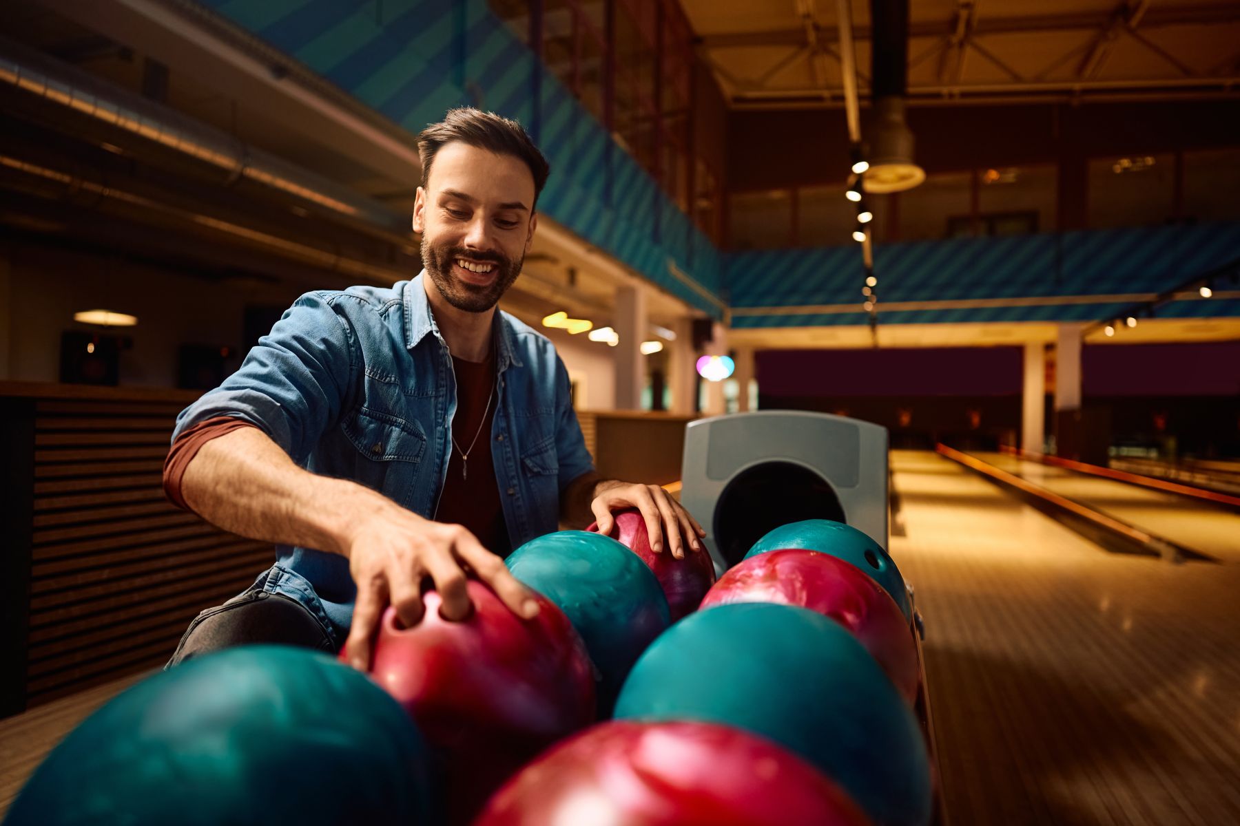 Man grabbing bowling ball